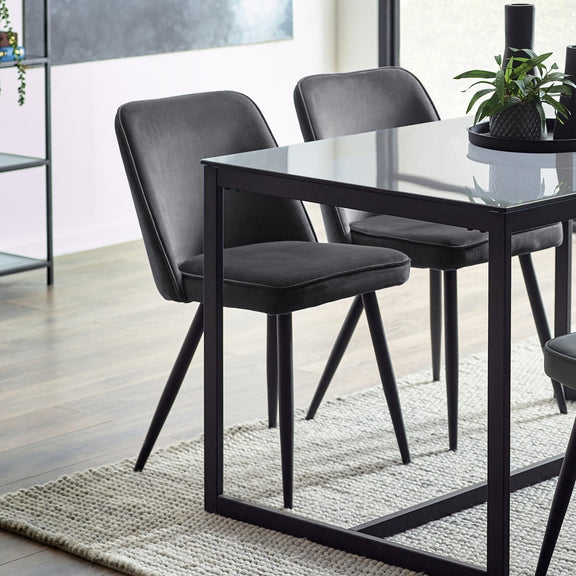 Dining table with black chairs in a modern room setting