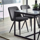 Dining table with black chairs in a modern room setting