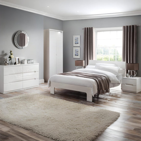 Modern bedroom with white furniture, gray walls, and a large window.