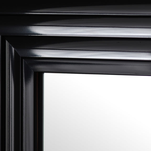 Close-up of a black framed mirror with reflective surface