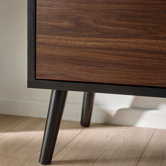 Wooden cabinet with dark legs on a wooden floor