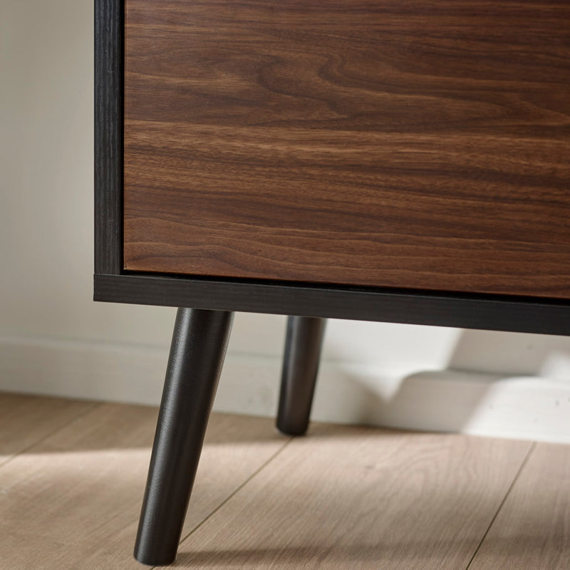 Wooden cabinet with dark legs on a wooden floor