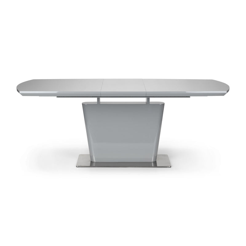 Modern dining table with a white surface and metallic base on a white background
