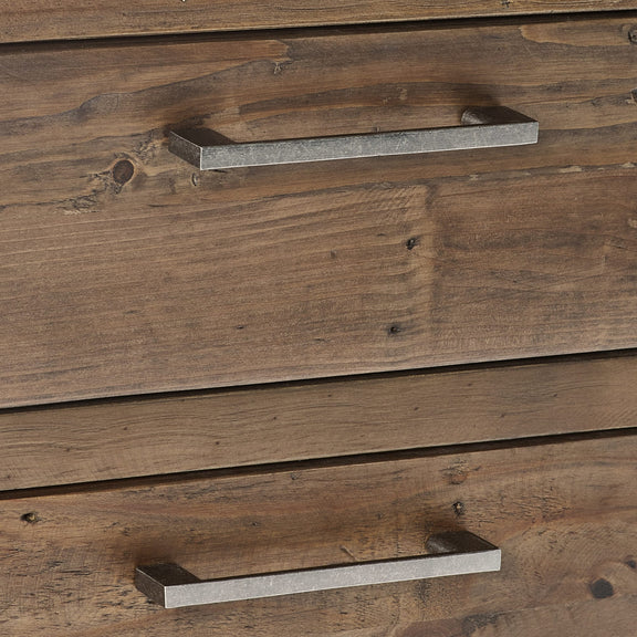 Close-up of wooden drawers with metal handles on a wooden cabinet.