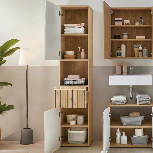 Bathroom with wooden cabinets and shelves containing toiletries and towels.