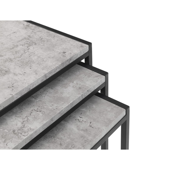 Set of three concrete tiered tables with black metal frames on a white background