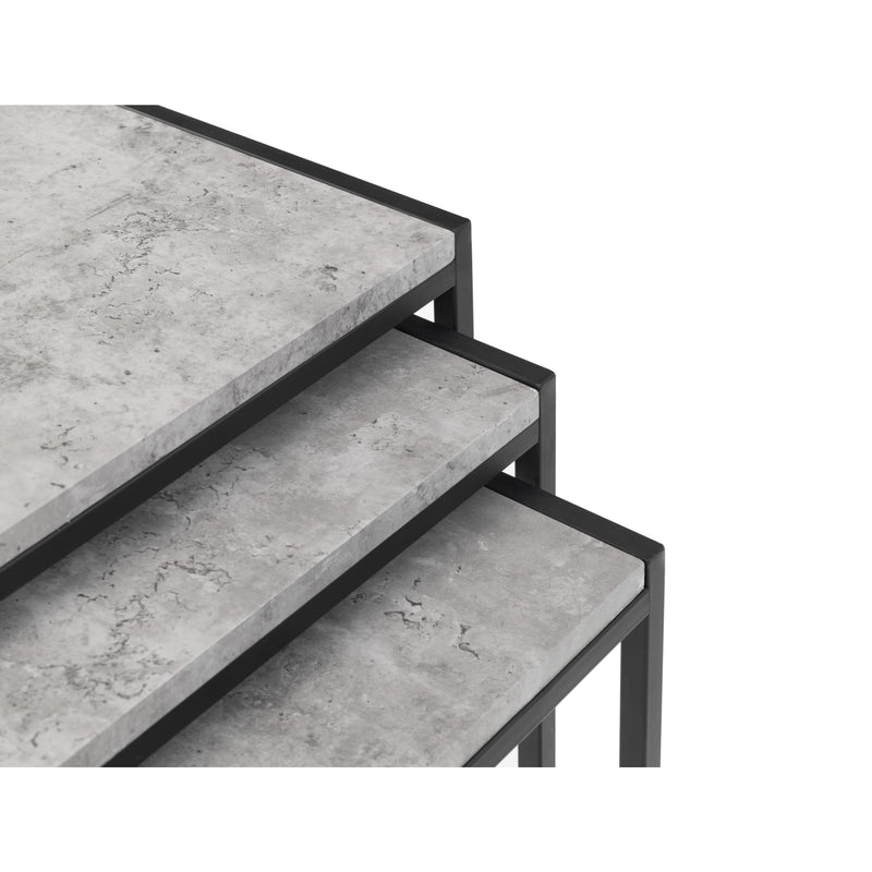 Set of three concrete tiered tables with black metal frames on a white background