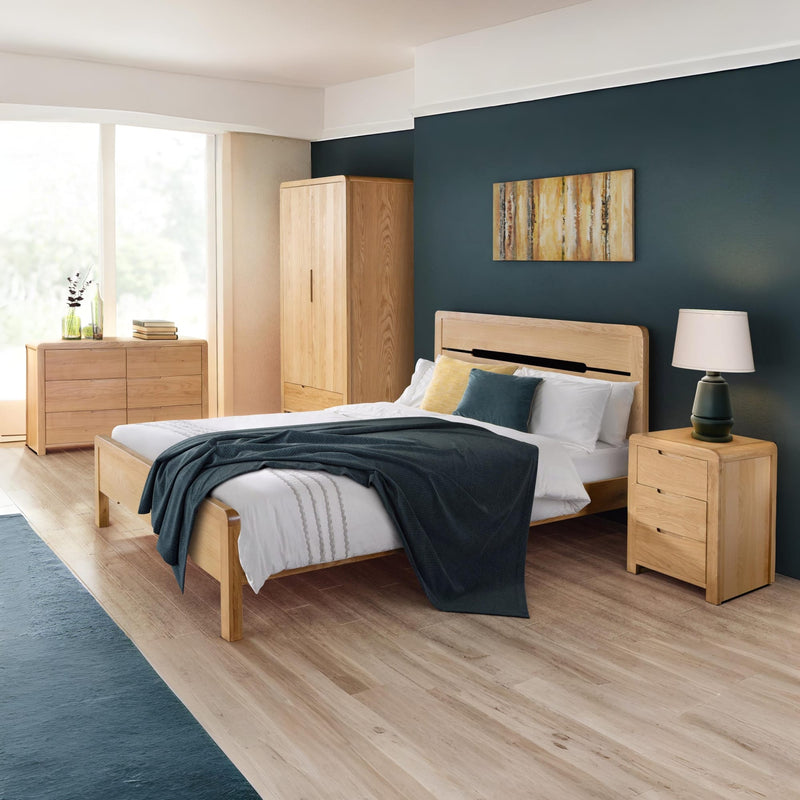 Modern bedroom with wooden furniture including a bed, wardrobe, and nightstand.