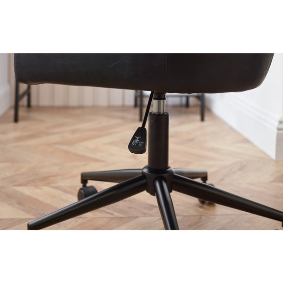 Black office chair with wheels on a wooden floor