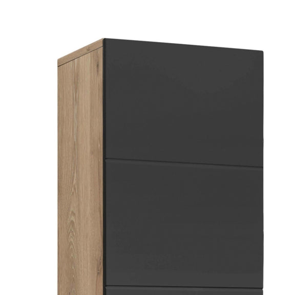 Tall cabinet with black doors and wooden side on a white background