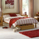Bedroom with wooden bed, red and white striped bedding, and decorative items.