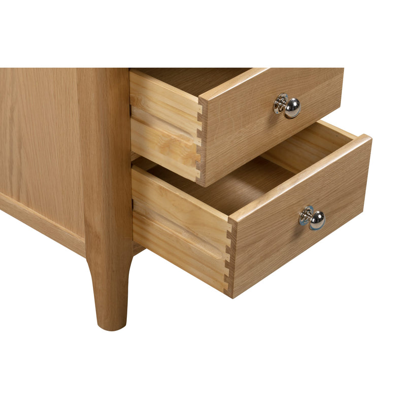 Wooden drawer unit with two open drawers on a white background