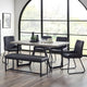 Dining room with a table and chairs in front of large windows.