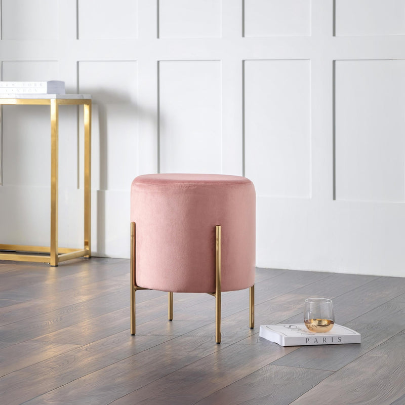 Pink stool with gold legs in a modern room setting