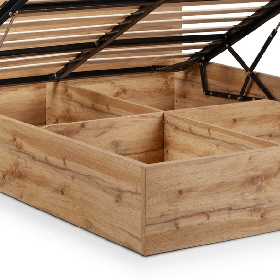 Wooden storage bed with open lid on a white background