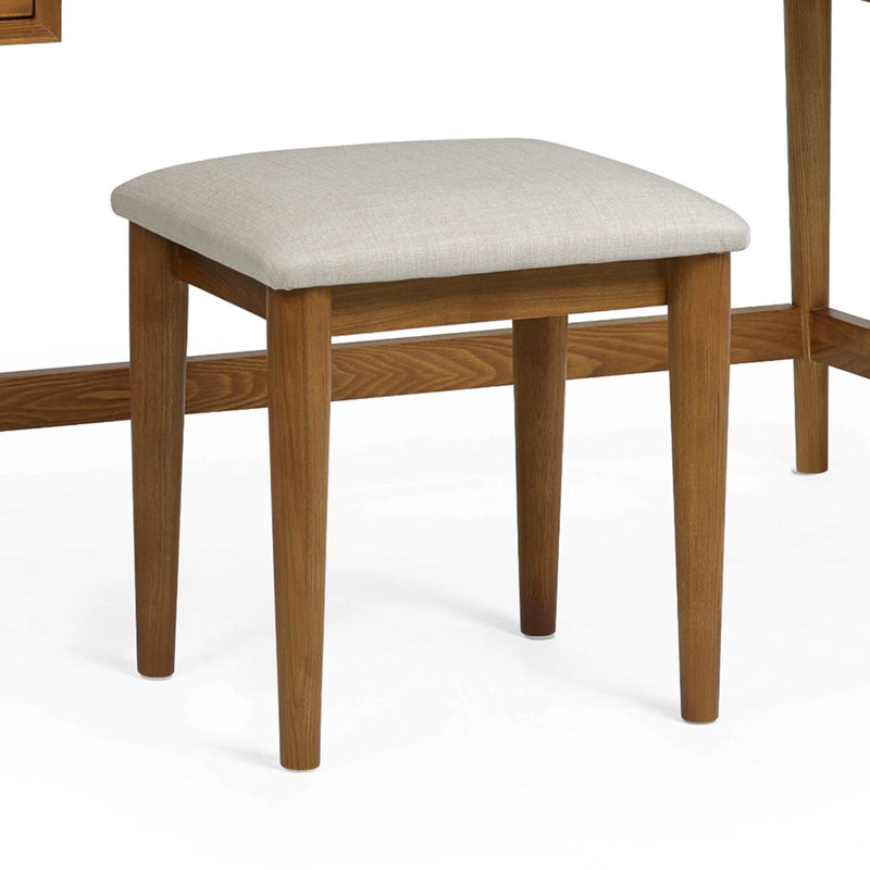 Wooden stool with a beige cushion on a white background