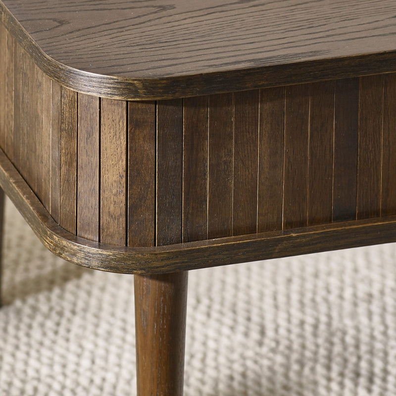 Close-up of a wooden side table with a textured background