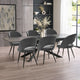 Dining room with a gray table and chairs in a modern interior setting.