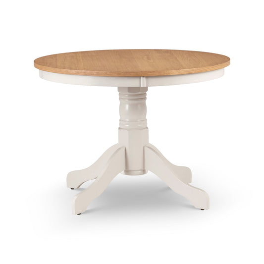 Round dining table with wooden top and white base on a white background