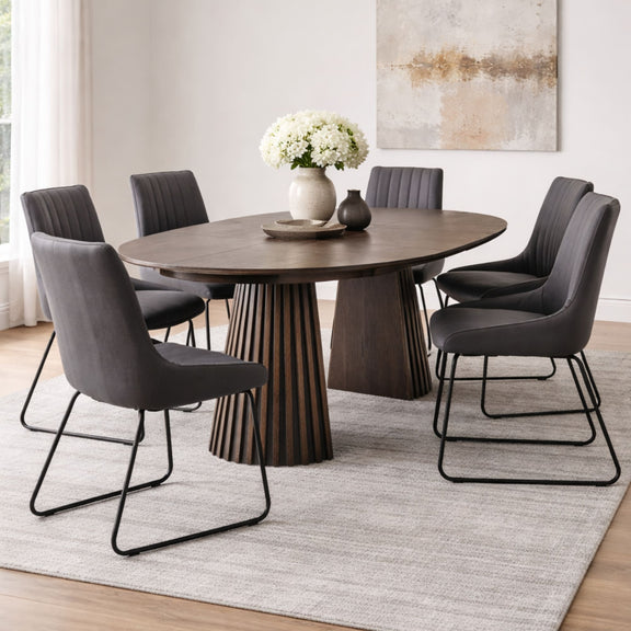 Dining room with a wooden table and gray chairs on a light rug.