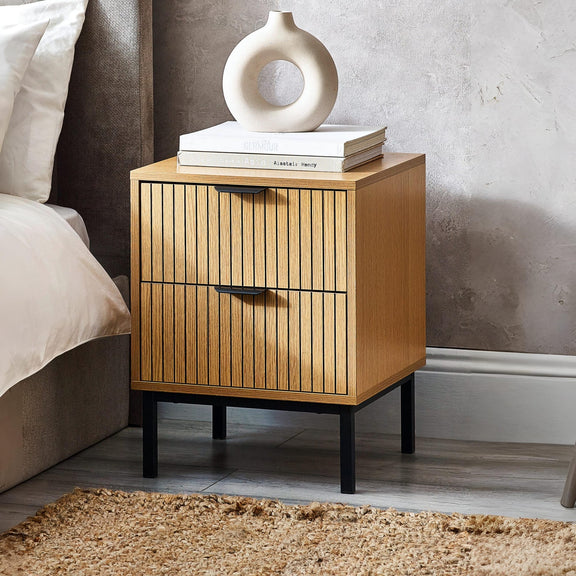 Wooden nightstand with a decorative item on top in a bedroom setting