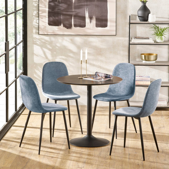 Dining room with a round table and four blue chairs in a modern interior setting.