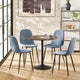 Dining room with a round table and four blue chairs in a modern interior setting.
