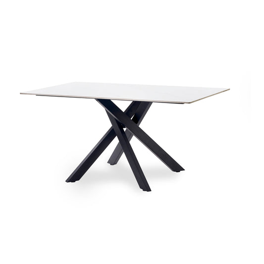 Modern dining table with white top and black metal legs on a white background