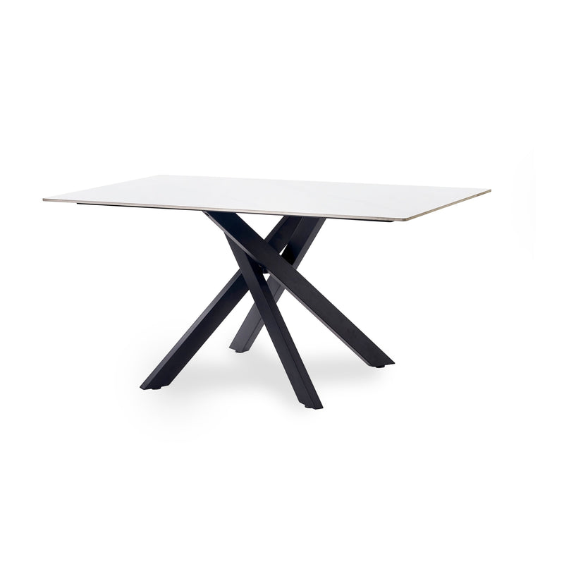 Modern dining table with white top and black metal legs on a white background