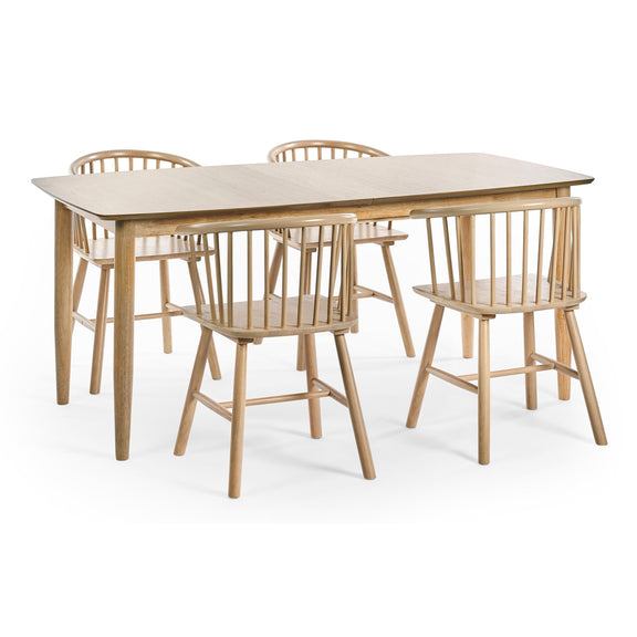 Wooden dining table with four matching chairs on a white background