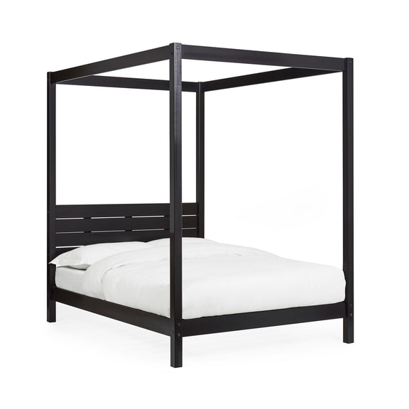Black canopy bed with white bedding on a white background