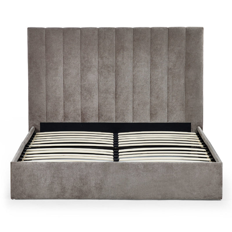 Gray upholstered bed with striped mattress on a white background