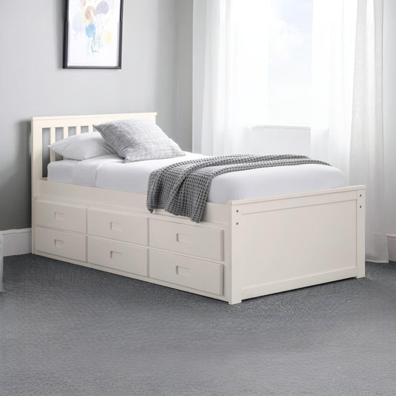 White bed with storage drawers in a bedroom setting
