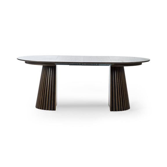 Round dining table with marble top and bronze base on a white background