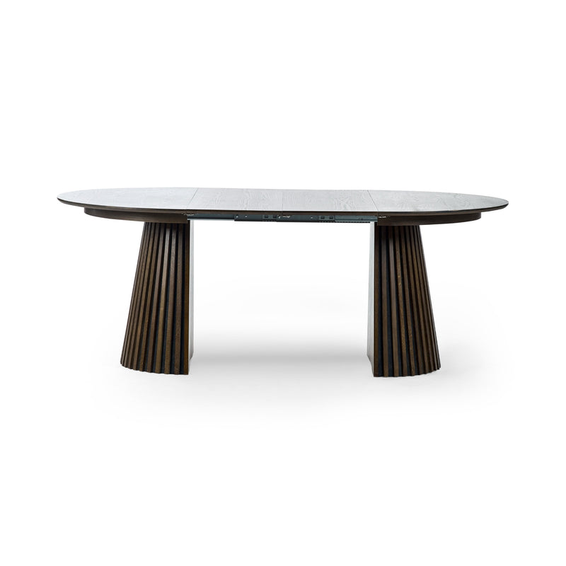 Round dining table with marble top and bronze base on a white background
