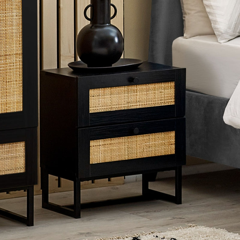 Black nightstand with woven drawers in a bedroom setting