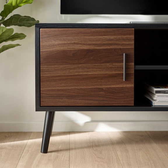 Wooden cabinet with a plant on a wooden floor