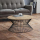 Wooden coffee table with black metal base in a living room setting