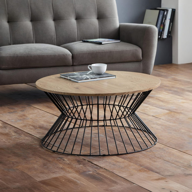 Wooden coffee table with black metal base in a living room setting