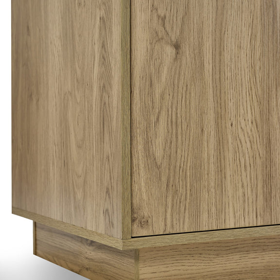 Close-up of a wooden cabinet with a light wood finish.