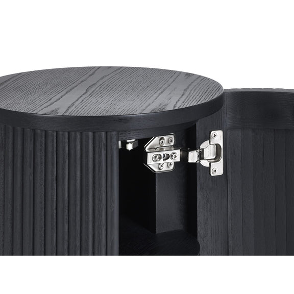 Close-up of a black wooden stool with a round top and visible hinges.