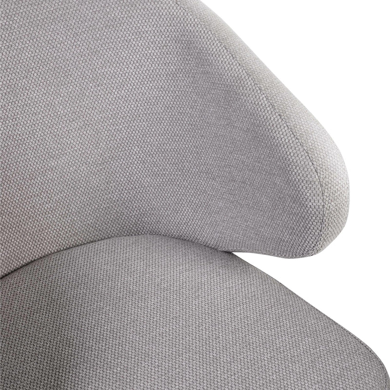 Close-up of a gray fabric chair with a plain background