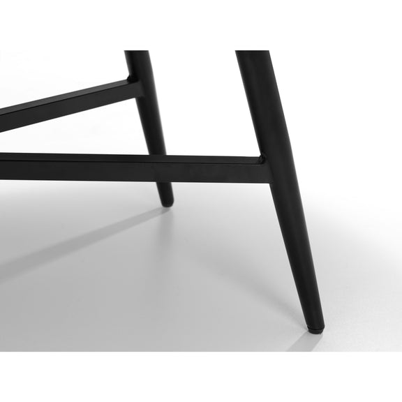 Close-up of a black metal chair frame on a white background