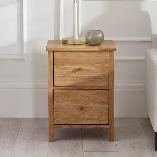 Wooden nightstand with two drawers in a room setting