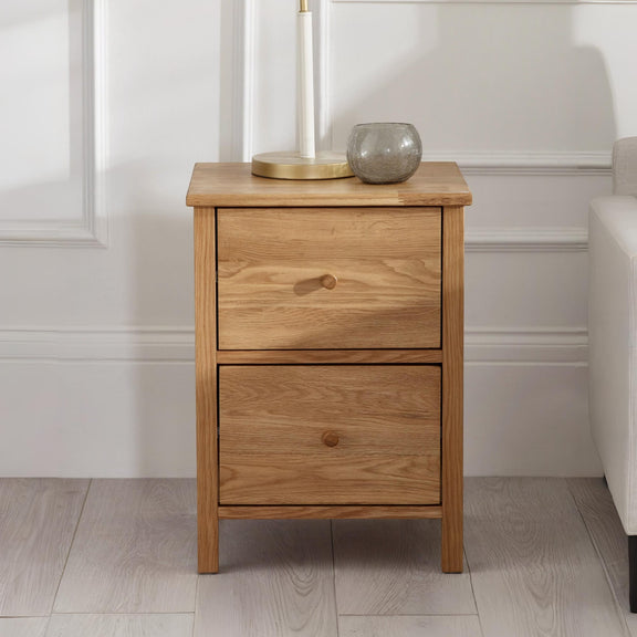 Wooden nightstand with two drawers in a room setting