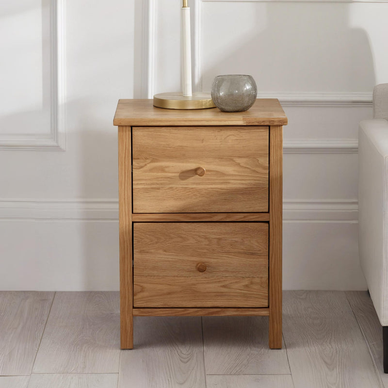 Wooden nightstand with two drawers in a room setting