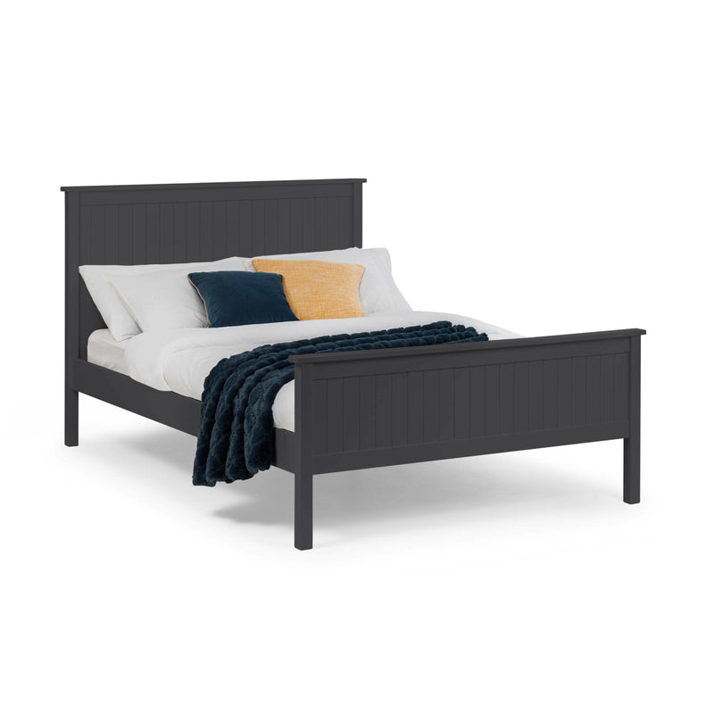Dark gray bed with white bedding and colorful pillows on a white background