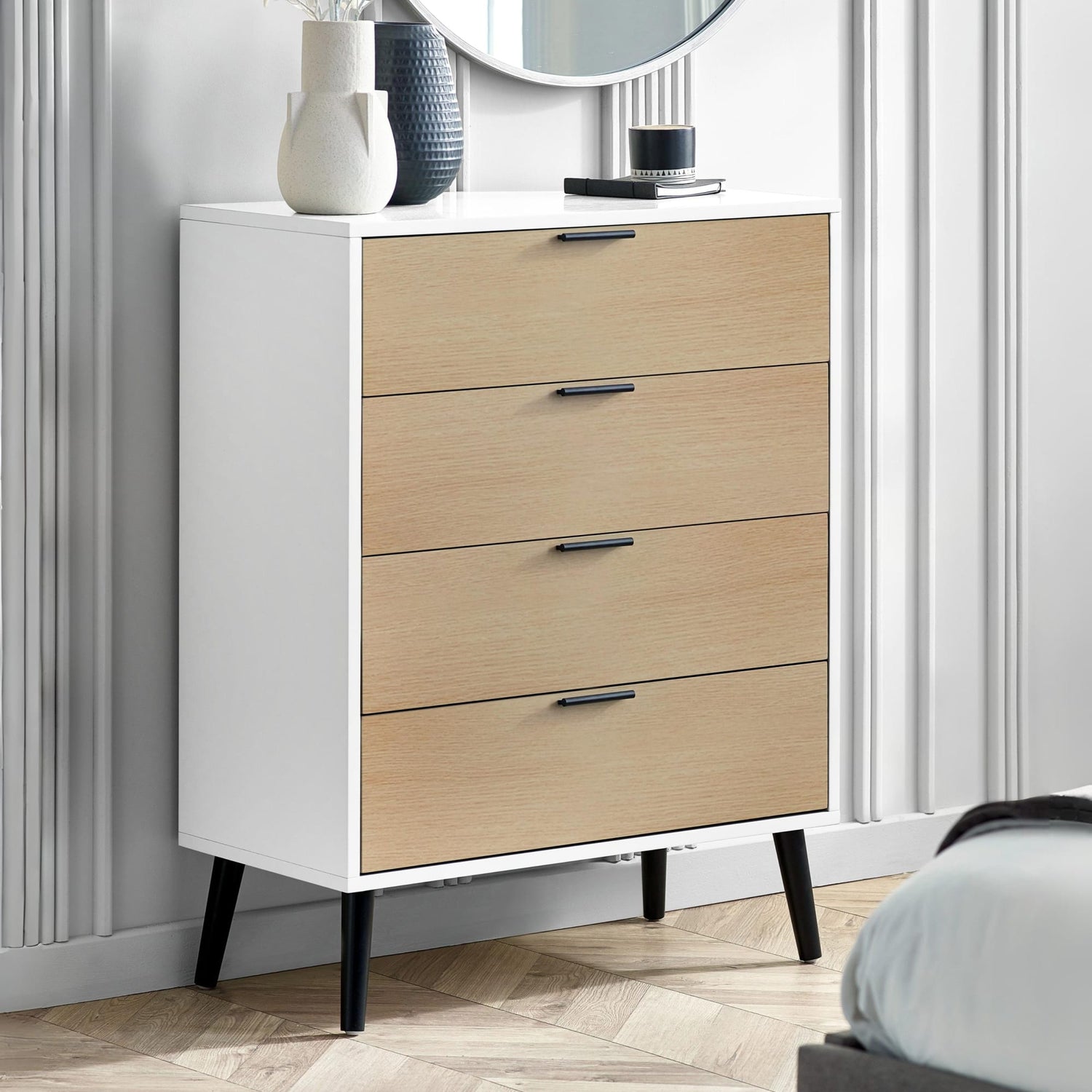White dresser with wooden drawers in a bedroom setting