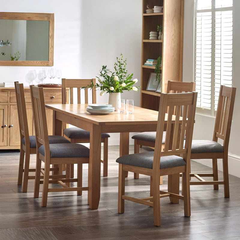 Wooden dining table with chairs in a well-lit room