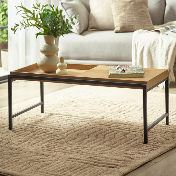 Wooden coffee table with decorative items in a living room setting